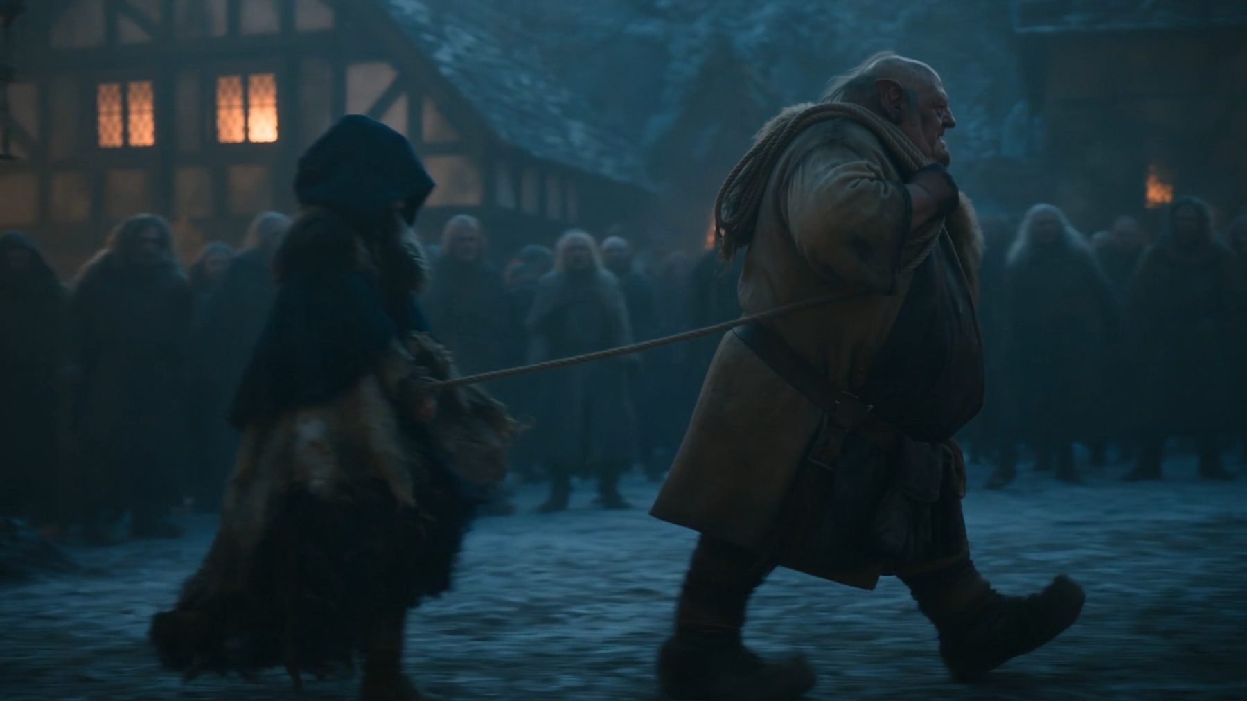 Seedance still — the executioner drags the hooded Aelira on a rope through the crowd