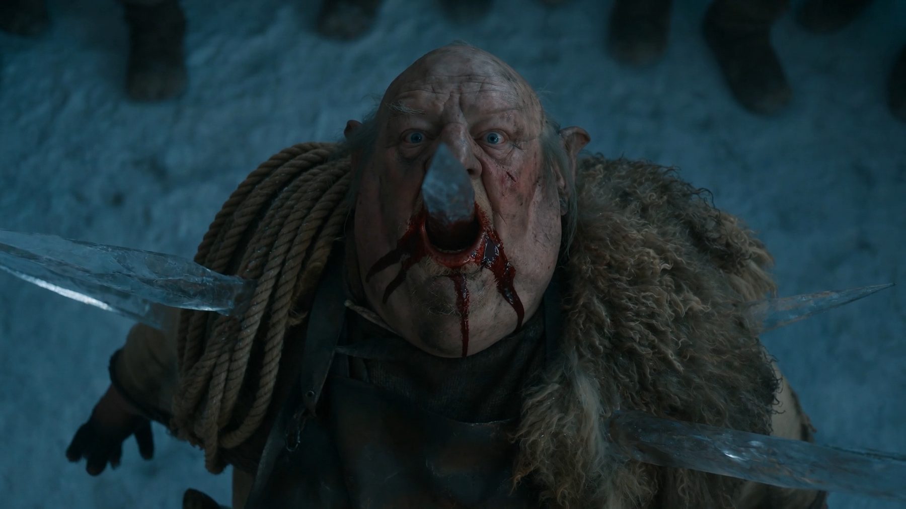 Seedance still — top-down on the executioner, ice point through his open mouth, blood along the ice